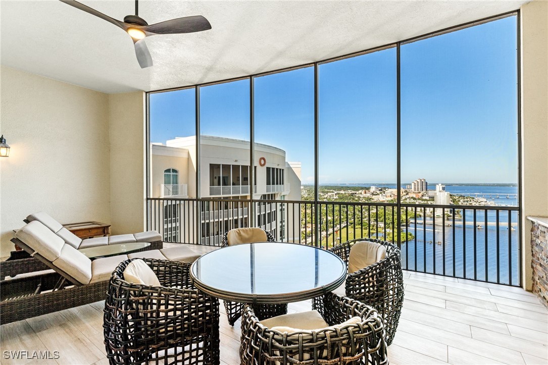 a balcony with a table and chairs