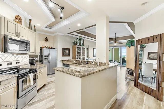 a kitchen with stainless steel appliances granite countertop a stove and a refrigerator