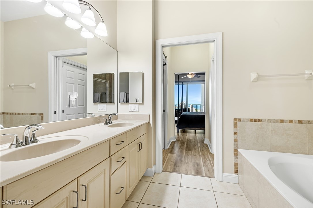 2745 First Street, Unit 2703 Fort Myers, FL 33916 - Photo 23 of 34 a spacious bathroom with a tub sink and mirror