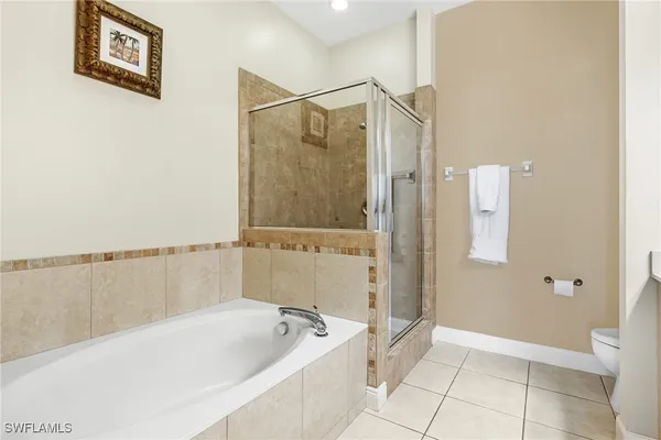 a bedroom with a bed and a large mirror