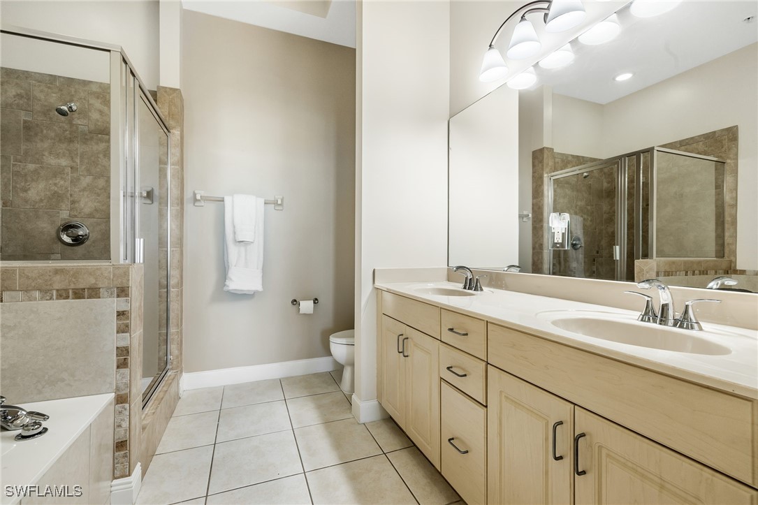 2745 First Street, Unit 2703 Fort Myers, FL 33916 - Photo 25 of 34 a bathroom with a sink a toilet and shower