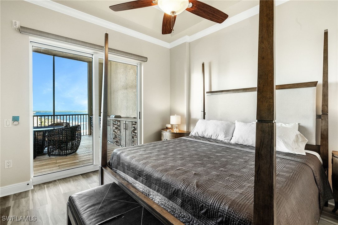 2745 First Street, Unit 2703 Fort Myers, FL 33916 - Photo 27 of 34 a bedroom with a large bed and a chandelier
