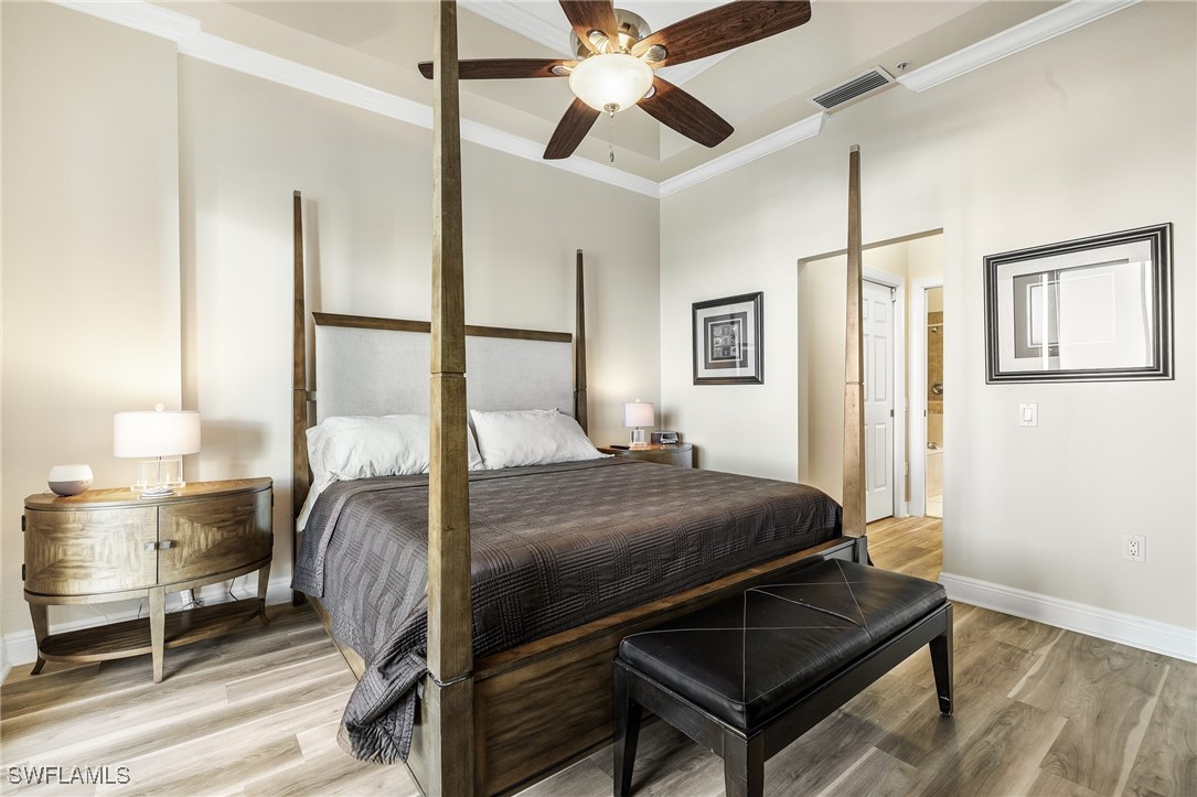 2745 First Street, Unit 2703 Fort Myers, FL 33916 - Photo 28 of 34 a bedroom with a bed and wooden floor