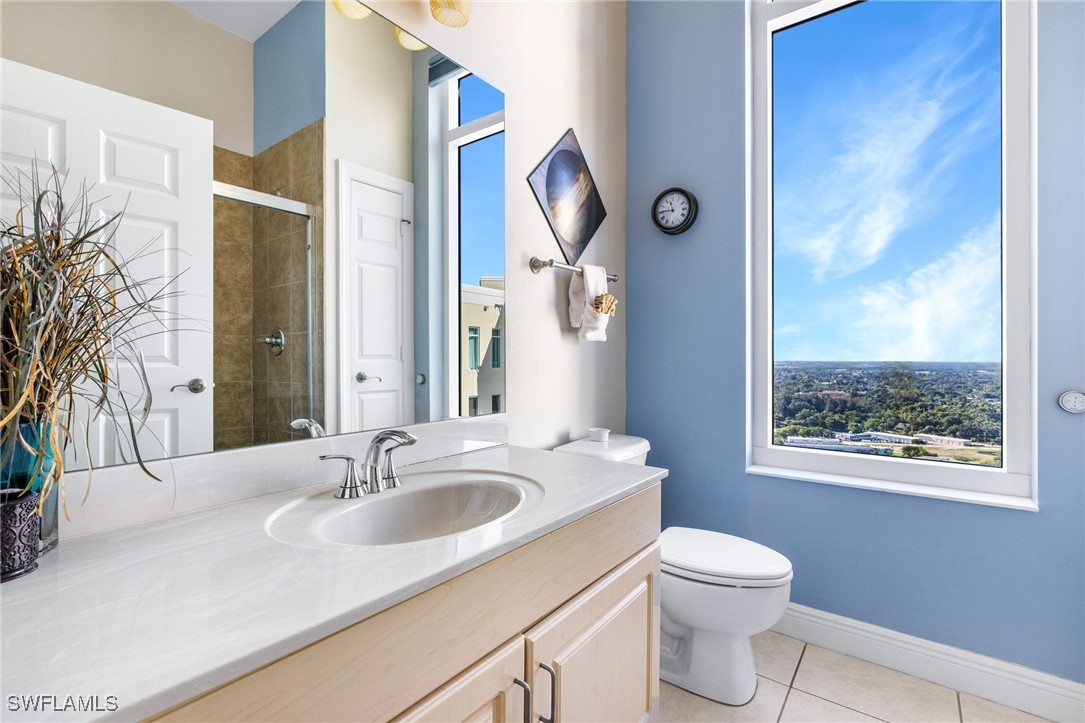2745 First Street, Unit 2703 Fort Myers, FL 33916 - Photo 5 of 34 a bathroom with a toilet a sink and a mirror