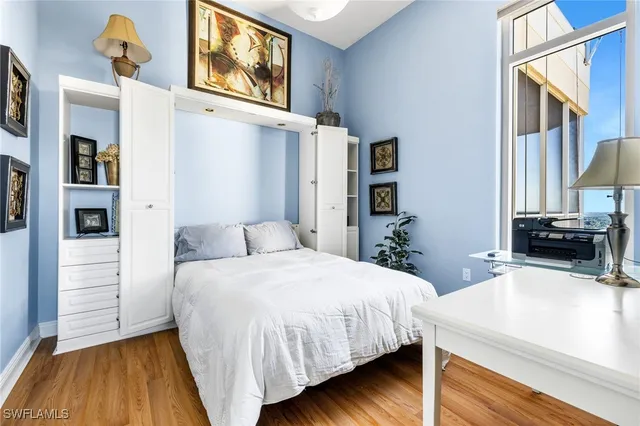 a bedroom with a bed and a flat tv screen on dresser
