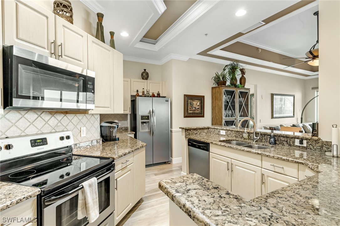 2745 First Street, Unit 2703 Fort Myers, FL 33916 - Photo 10 of 34 a kitchen with stainless steel appliances granite countertop a stove and a sink