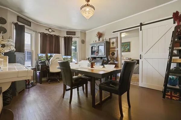 a view of a dining room with furniture and window