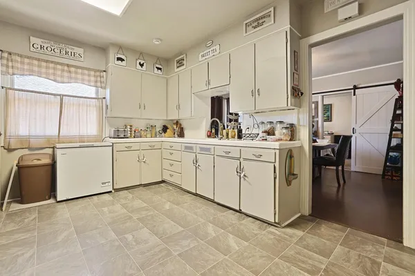a kitchen with a sink a stove and cabinets