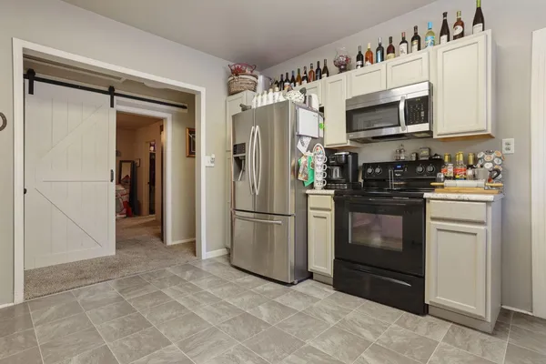 a kitchen with stainless steel appliances a refrigerator stove and microwave