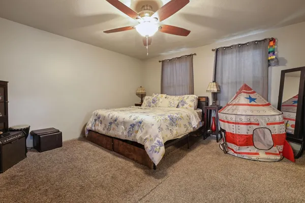 a bedroom with bed and a chandelier