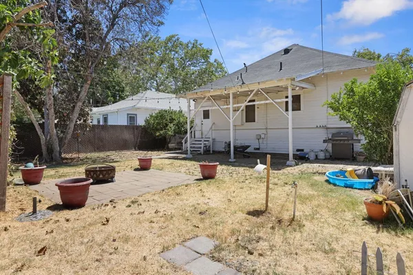 a view of a house with yard and sitting area
