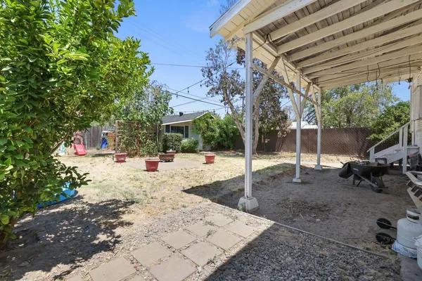 a view of a backyard with sitting area