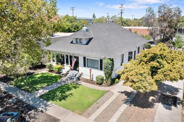 a aerial view of a house with a yard table and chairs