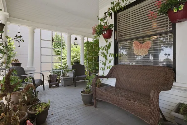 a living room with furniture and a potted plant