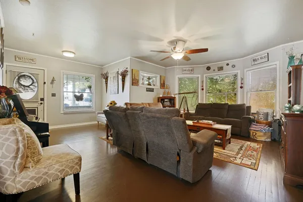 a living room with furniture and wooden floor