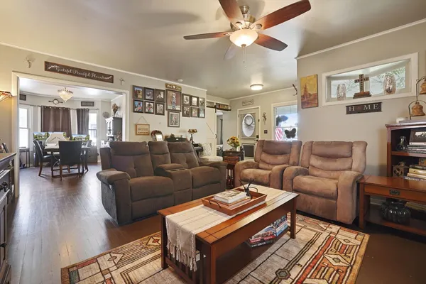 a living room with furniture a rug and a chandelier