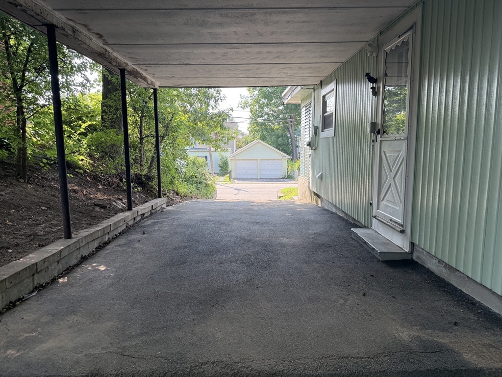 36 5th Avenue Lowell, MA 01854 - Photo 4 of 16 a view of an empty room with a sliding door and balcony
