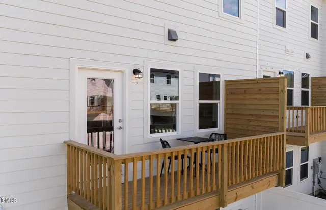 a view of a house with a wooden fence