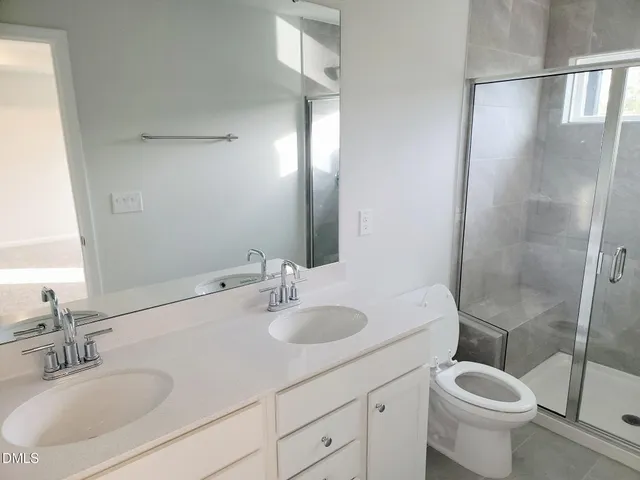 a bathroom with a sink toilet and a mirror