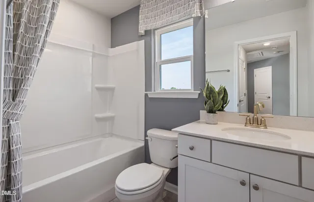a bathroom with a sink toilet vanity tub and shower