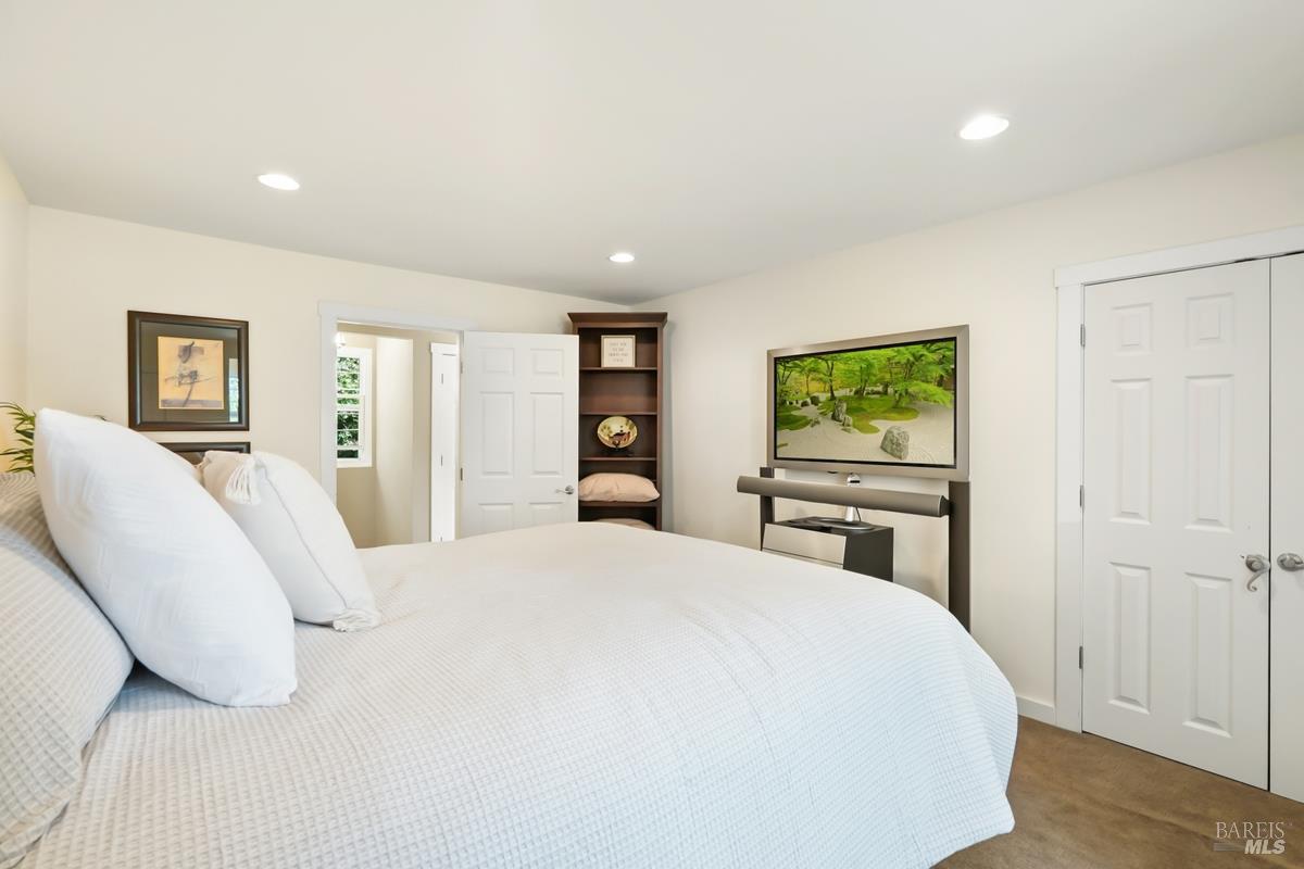 1846 Indian Valley Road, Unit A Novato, CA 94947 - Photo 37 of 45 a bedroom with a large bed and a tv