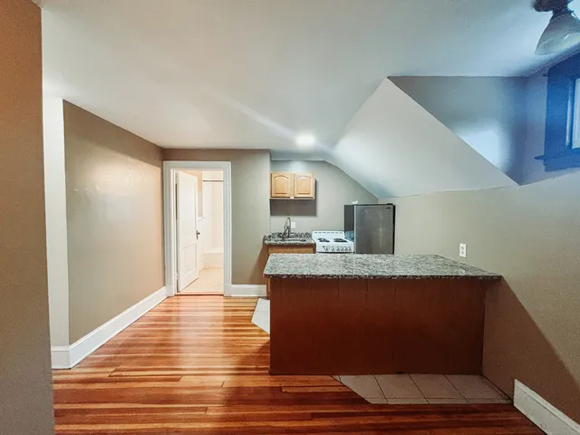a view of kitchen with cabinets and wooden floor