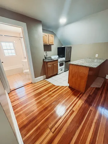 a view of a kitchen from a hallway