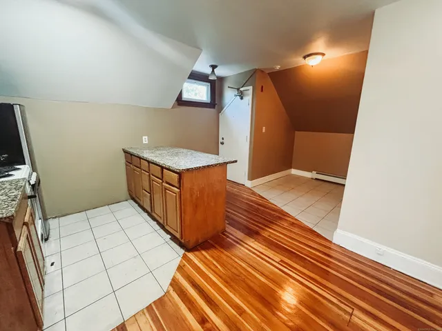 a bathroom with a sink a toilet a mirror a vanity and shower