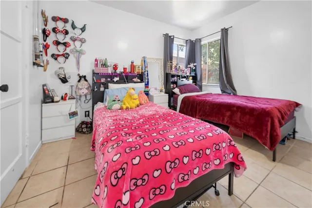 a bedroom with two beds and painted walls