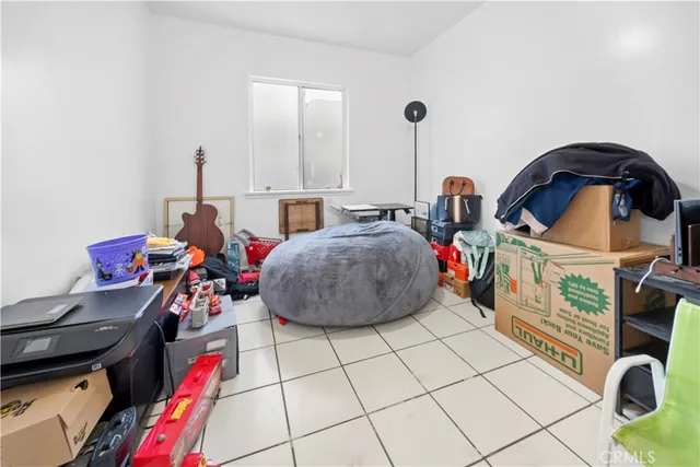 a bedroom with a bed window and dresser