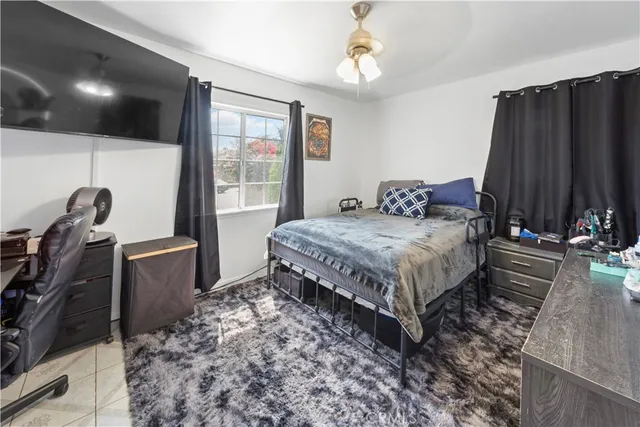 a bed sitting in a bedroom next to a window