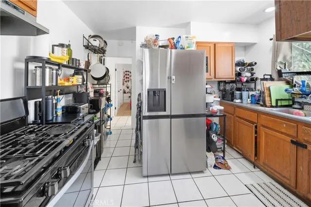 a kitchen with a refrigerator and a stove top oven