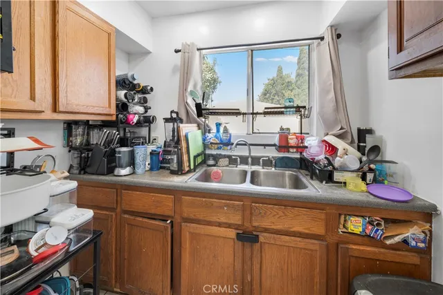a kitchen with a sink cabinets and a window