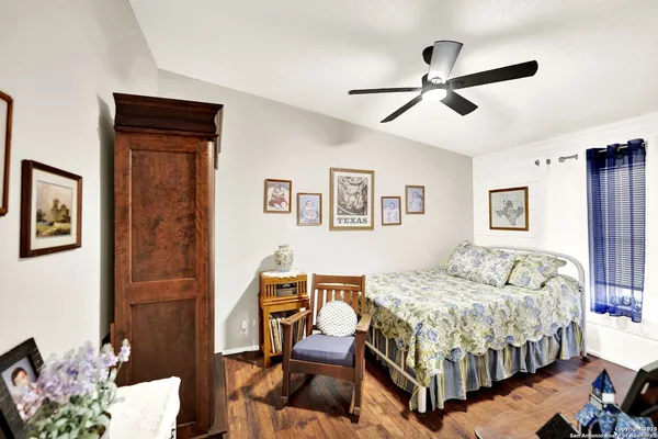 a bedroom with a bed wooden floor and window