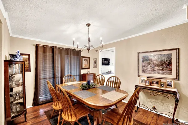 a view of a a dining room with furniture window and wooden floor