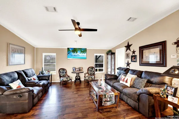 a living room with furniture and wooden floor