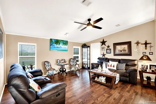 a living room with furniture and a wooden floor