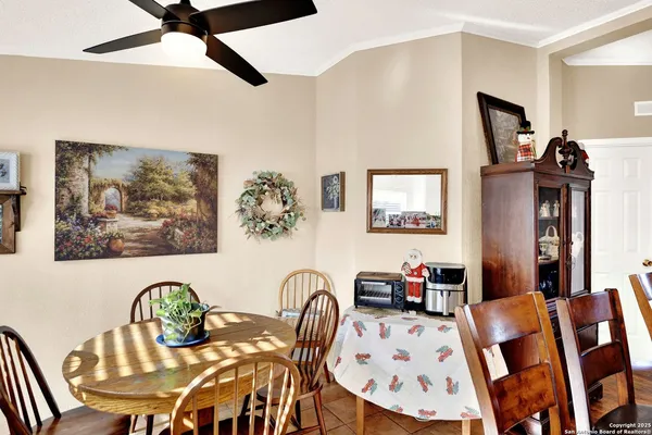 a view of a dining room with furniture and a chandelier