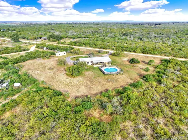 an aerial view of a house with big yard