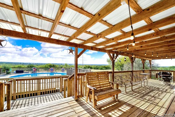 a view of a balcony with wooden floor