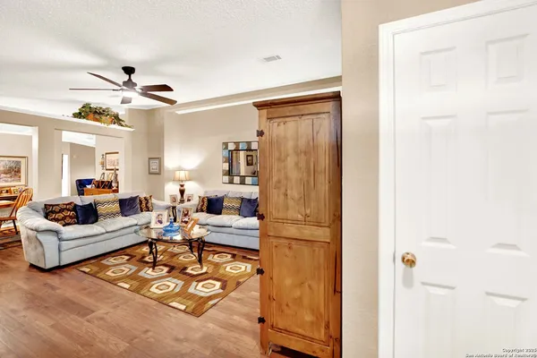 a living room with furniture and a ceiling fan