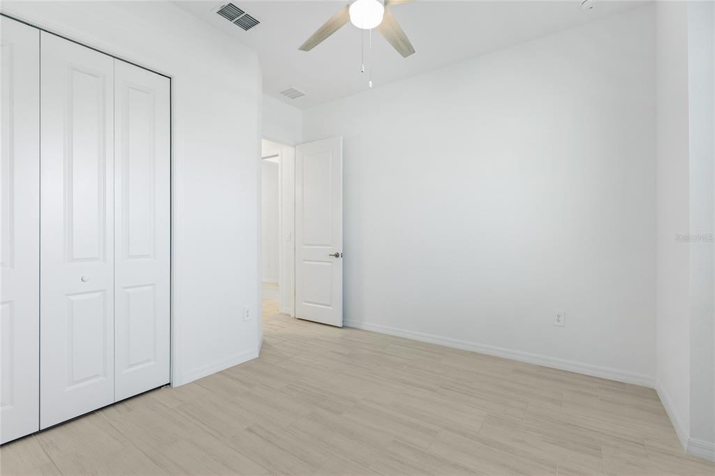 19156 Cherrystone Way Lakewood Ranch, FL 34211 - Photo 25 of 49 an empty room with a ceiling fan and a window