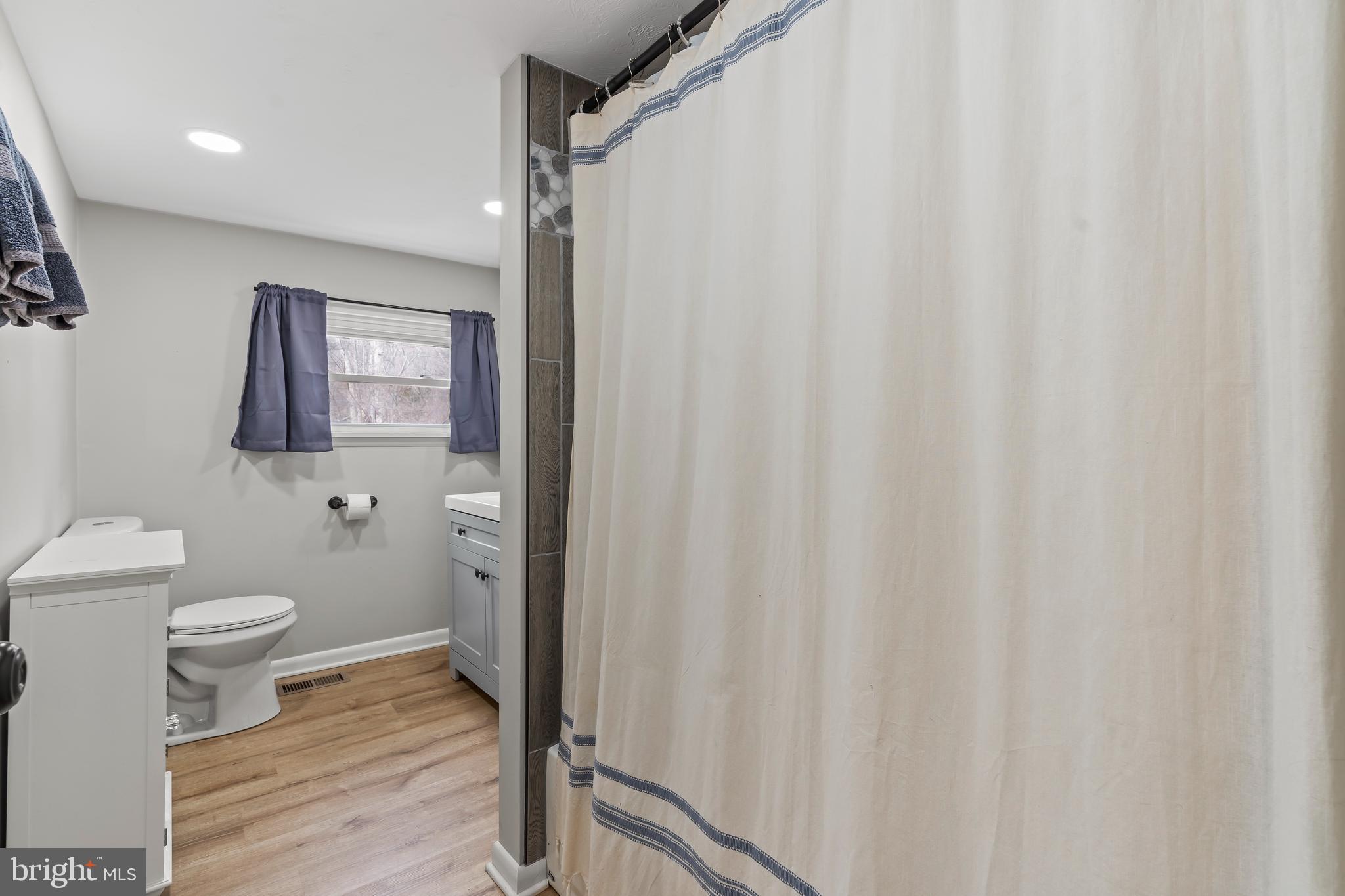 5150 Nursery Road Dover, PA 17315 - Photo 14 of 38 a bathroom with a toilet and a shower curtain