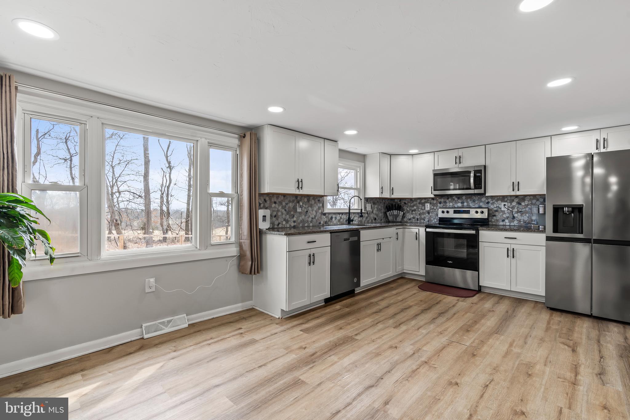 5150 Nursery Road Dover, PA 17315 - Photo 6 of 38 a kitchen with granite countertop stainless steel appliances refrigerator cabinets and a window