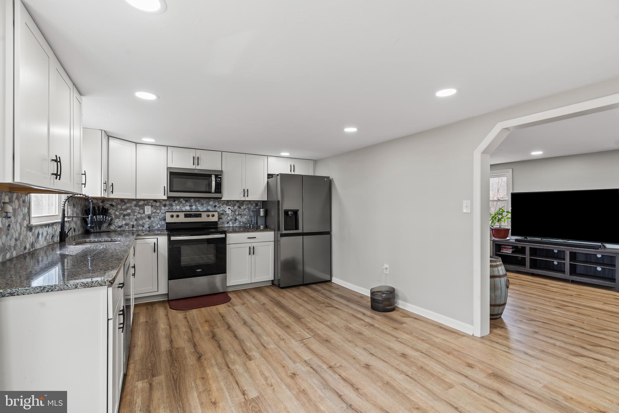 5150 Nursery Road Dover, PA 17315 - Photo 7 of 38 a kitchen with granite countertop a refrigerator and a stove top oven