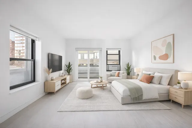 a large bedroom with a bed and large window