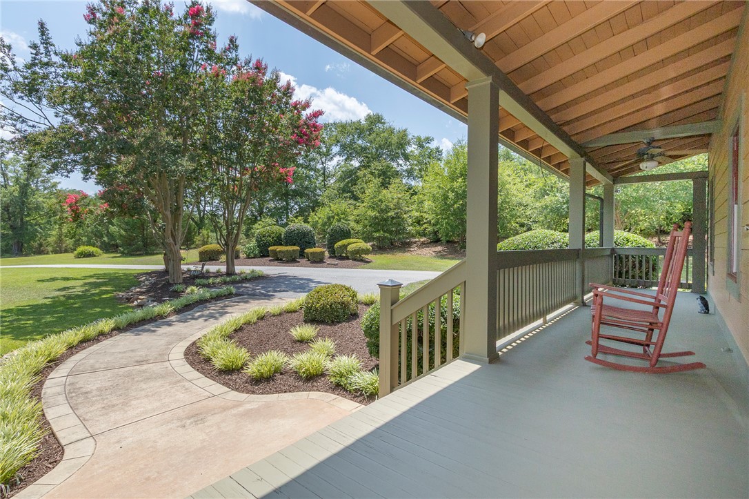 911 State Rd S-4-203 Belton, SC 29627 - Photo 7 of 49 A grand covered porch and inviting pathway welcome you to this private, verdant estate.