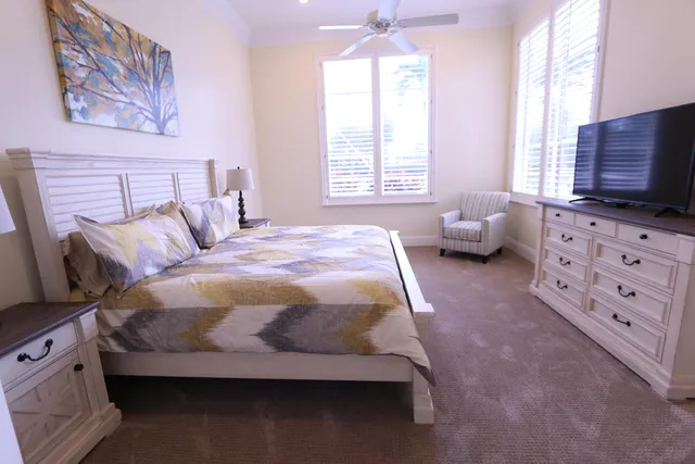 a bedroom with a bed a couch and dresser