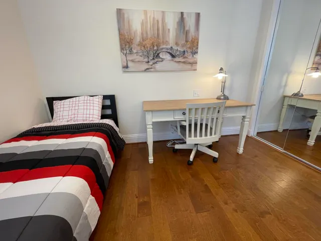 a bedroom with a bed and a chair