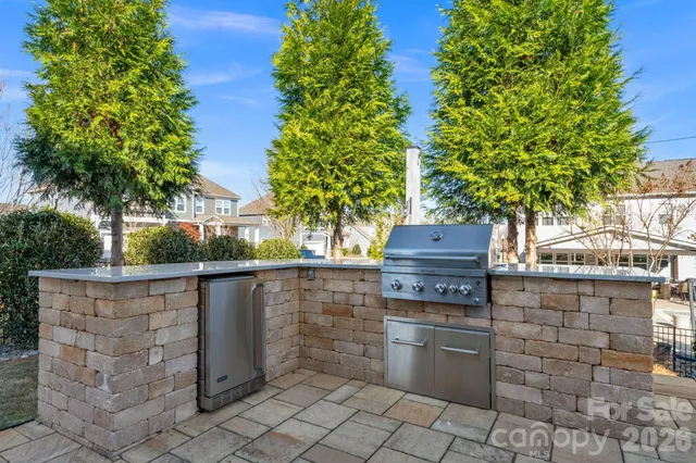 a backyard of a house with barbeque oven